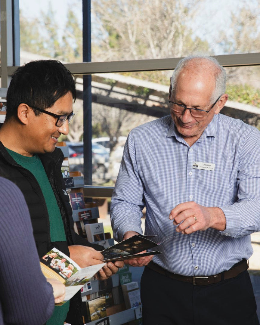 Man showing Hunter Valley brochures to visitors