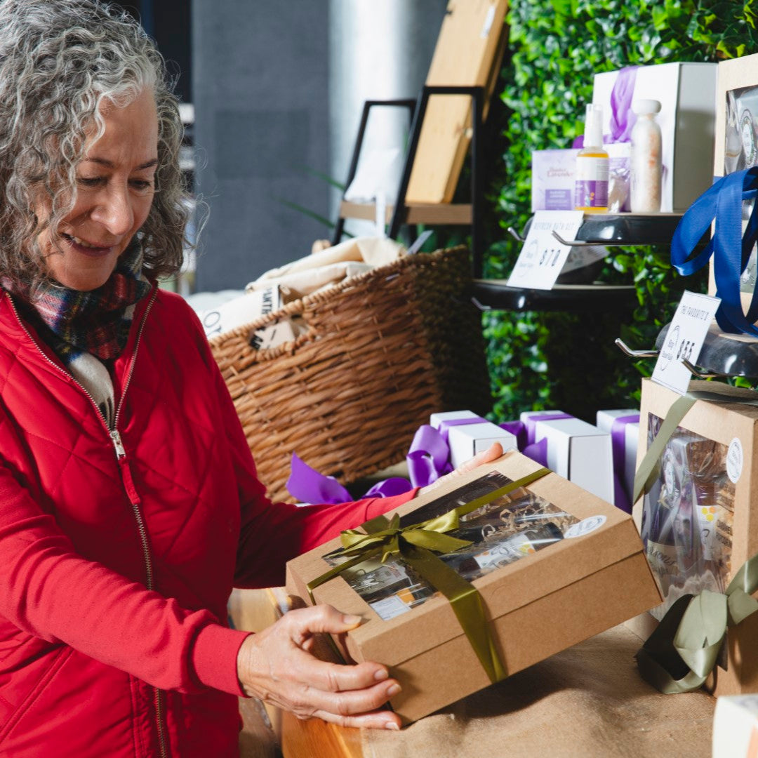 Woman in a red coat selecting a gift box