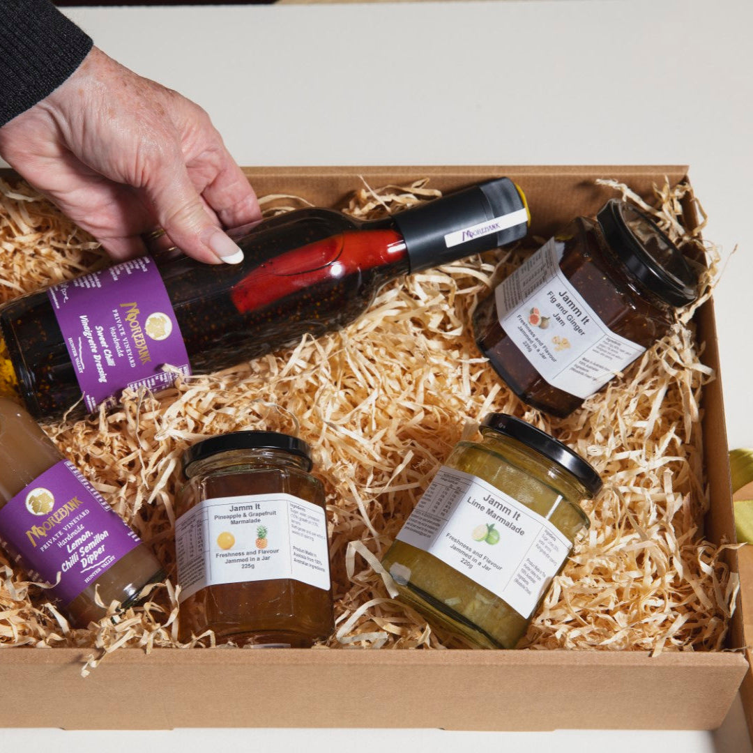 Gift box with assorted jars and bottles on a white background